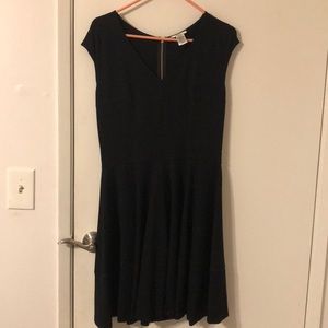 Black knee length dress with zipper embellishment